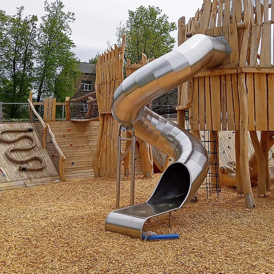 Stainless steel tunnel / tube slide for a playground.